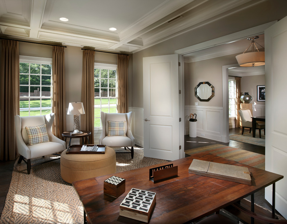 Photo of a large traditional study room in Charlotte with beige walls, dark hardwood floors and a freestanding desk.