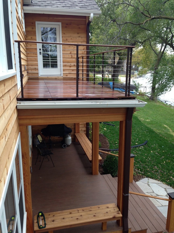 Inspiration for a mid-sized midcentury rooftop deck in Milwaukee with a roof extension.