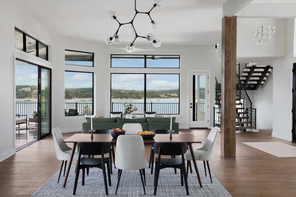 Large contemporary dining room in Austin with white walls, light hardwood floors and beige floor.