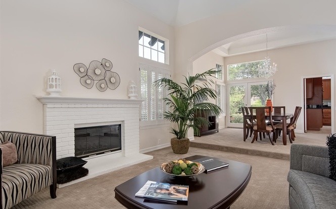 Photo of a large transitional formal open concept living room in San Diego with beige walls, carpet, a standard fireplace, a brick fireplace surround and no tv.