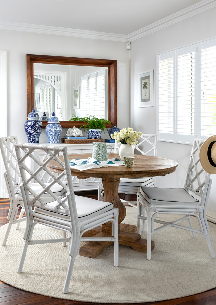 Photo of a beach style dining room in Brisbane with dark hardwood floors, no fireplace and white walls.