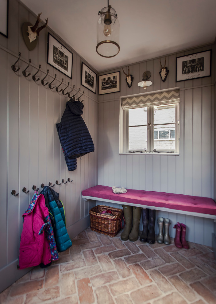 Small traditional entryway in Hampshire with grey walls and brick floors.