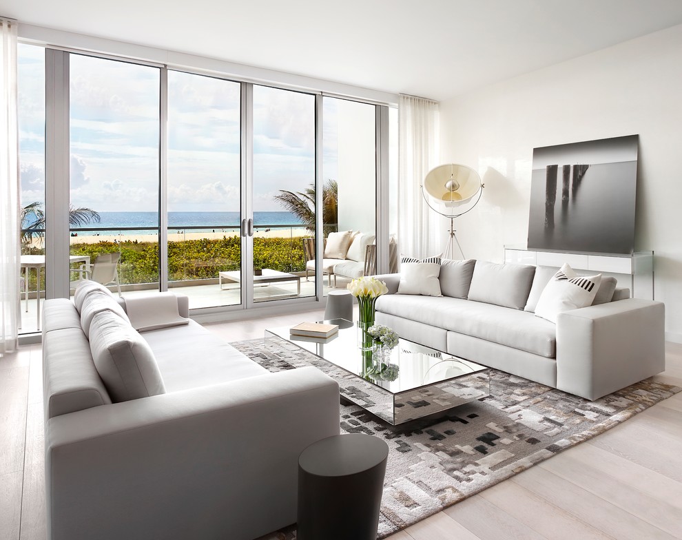 Inspiration for a large contemporary formal enclosed living room in Miami with white walls, light hardwood floors, no fireplace, no tv and brown floor.