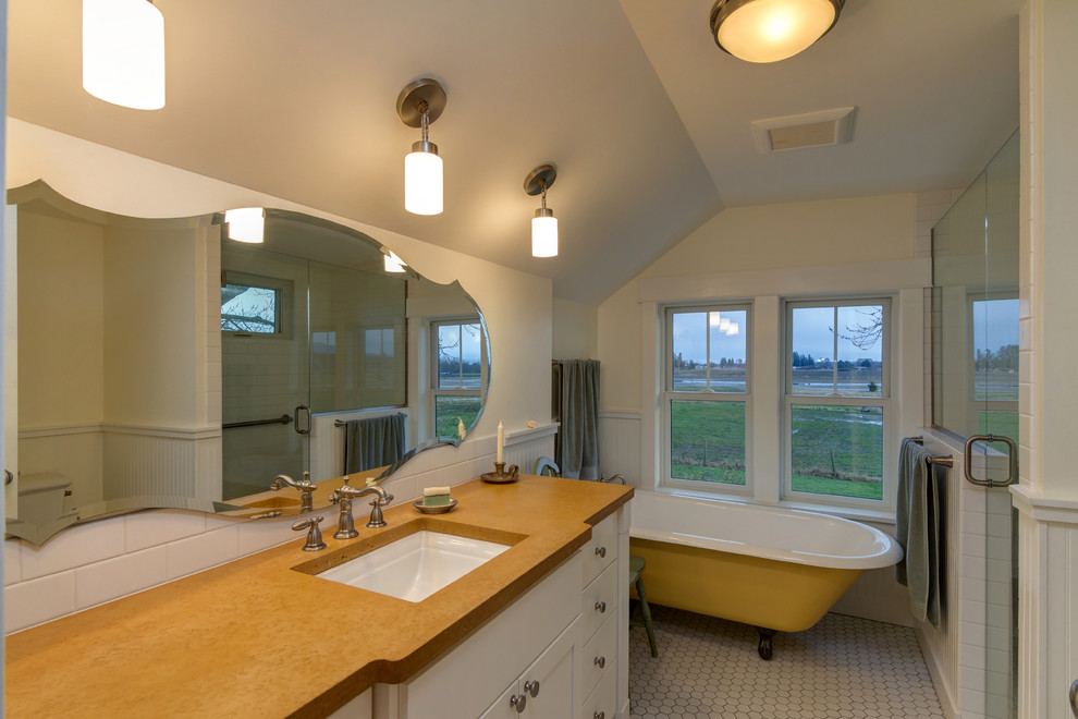 Design ideas for a mid-sized country 3/4 bathroom in Seattle with raised-panel cabinets, medium wood cabinets, a drop-in tub, an open shower, a one-piece toilet, white tile, yellow tile, stone slab, white walls, porcelain floors, a drop-in sink and solid surface benchtops.
