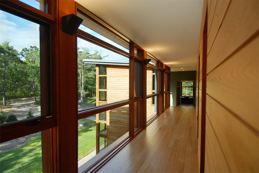 This is an example of a modern hallway in Providence with medium hardwood floors.