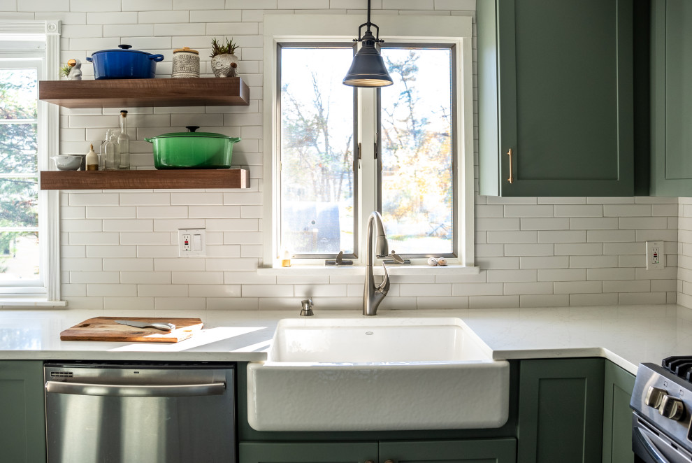 Inspiration for a huge transitional galley vinyl floor and brown floor kitchen remodel in Boston with a farmhouse sink, flat-panel cabinets, green cabinets, quartzite countertops, white backsplash, ceramic backsplash, stainless steel appliances, an island and white countertops
