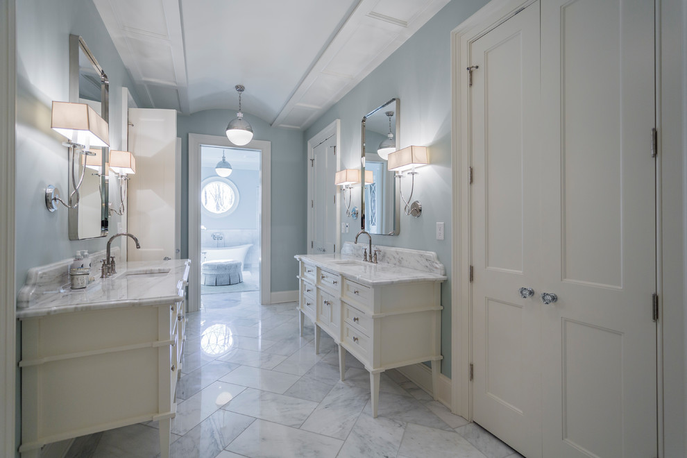 Design ideas for a traditional master bathroom in Louisville with white cabinets, a freestanding tub, blue walls, an undermount sink, white floor and beaded inset cabinets.