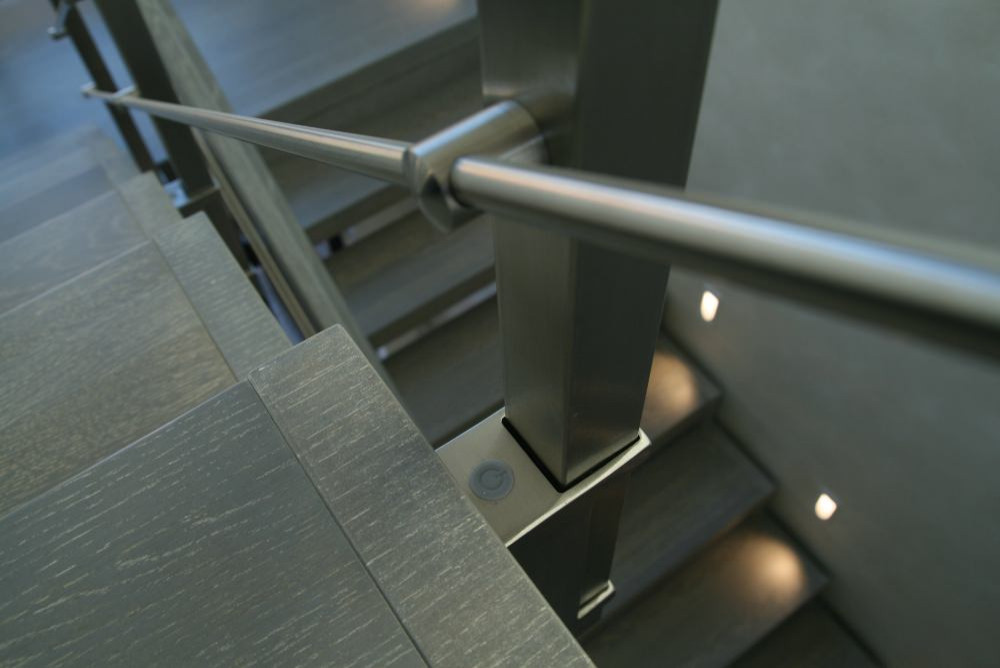 Modern metal stair covered by patina oak
