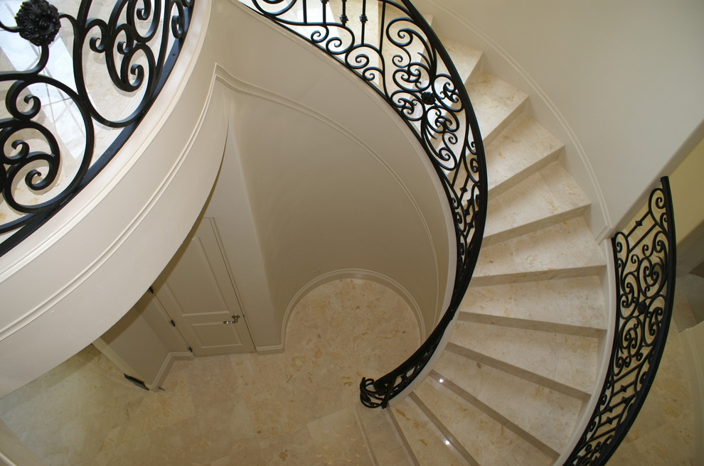 Large tuscan tile curved staircase photo in Dallas with tile risers