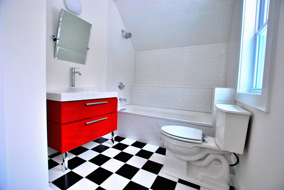 Design ideas for a traditional bathroom in New York with an integrated sink, flat-panel cabinets, red cabinets, an alcove tub, a shower/bathtub combo, white tile, subway tile and multi-coloured floor.