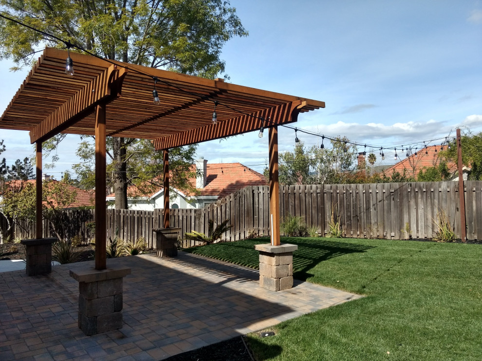 Design ideas for a backyard concrete paver landscaping in San Francisco with a pergola.