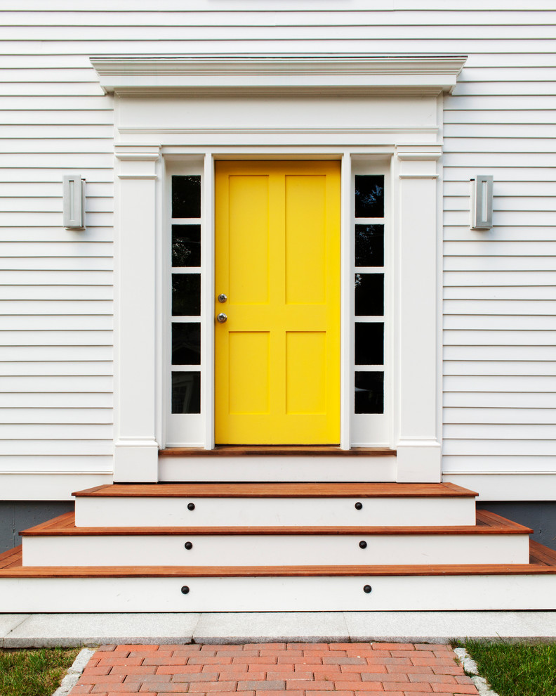 This is an example of a transitional front door in Boston with a single front door and a yellow front door.
