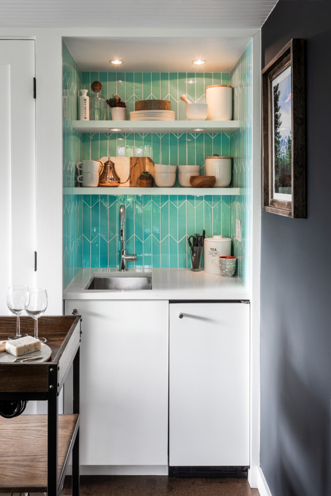 Design ideas for a small contemporary bar cart in Seattle with an undermount sink, flat-panel cabinets, white cabinets, solid surface benchtops, blue splashback, ceramic splashback, cork floors, brown floor and white benchtop.