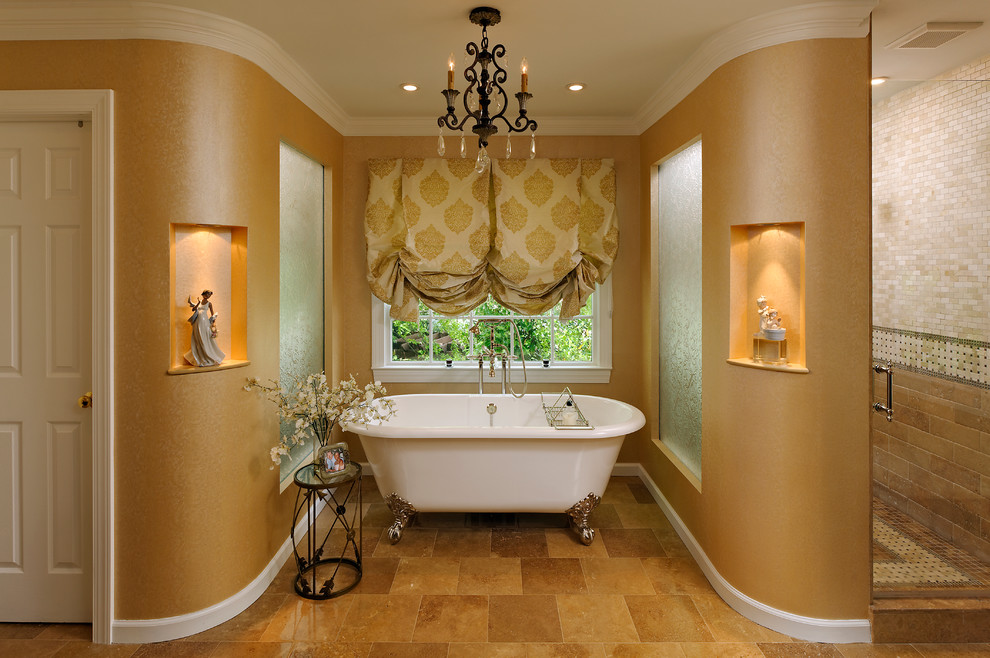 Photo of a traditional bathroom in DC Metro with a claw-foot tub and stone tile.