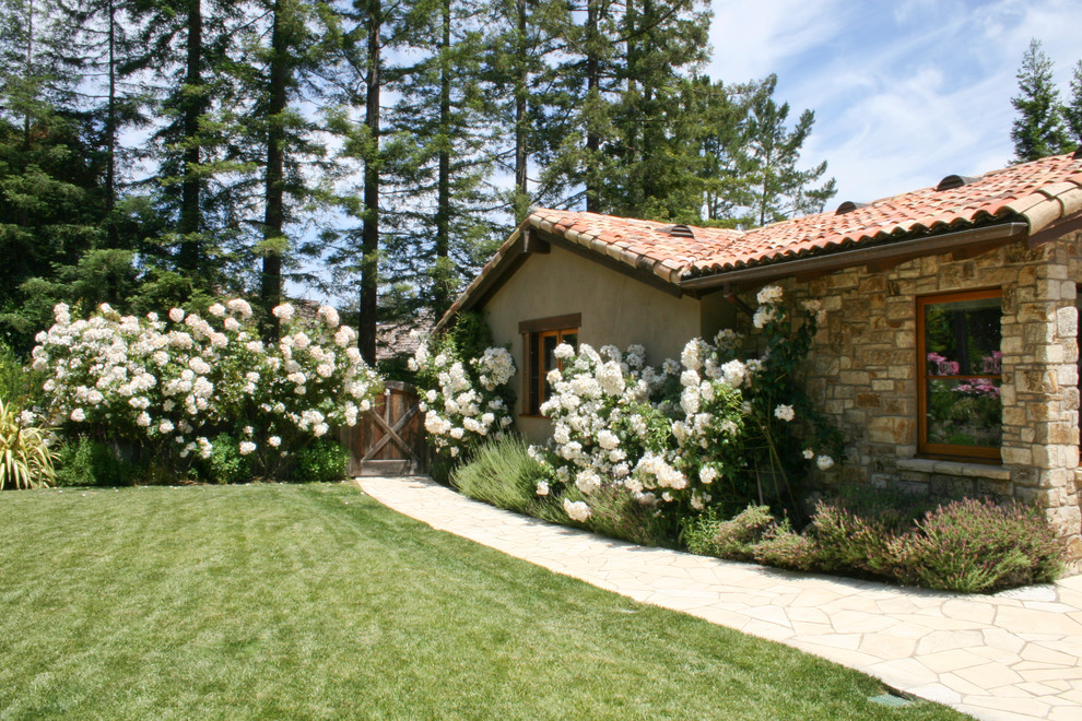 Photo of a traditional exterior in Other with stone veneer.