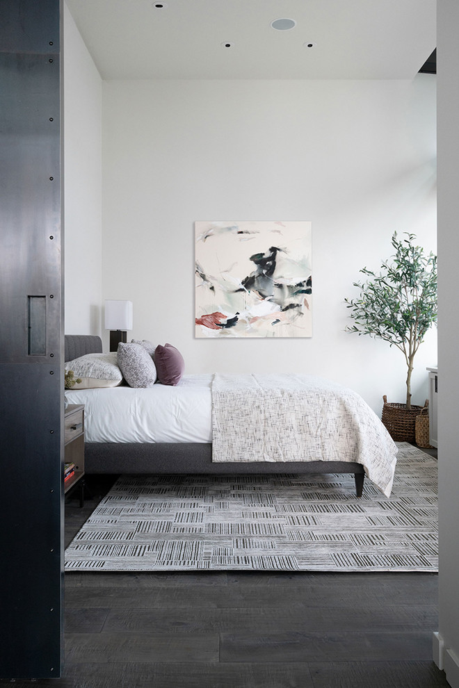 Mid-sized industrial master bedroom in Seattle with white walls, dark hardwood floors and no fireplace.