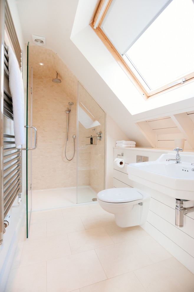 Beach style bathroom in Cornwall with a wall-mount sink, an alcove shower, a wall-mount toilet, beige tile, mosaic tile and white walls.