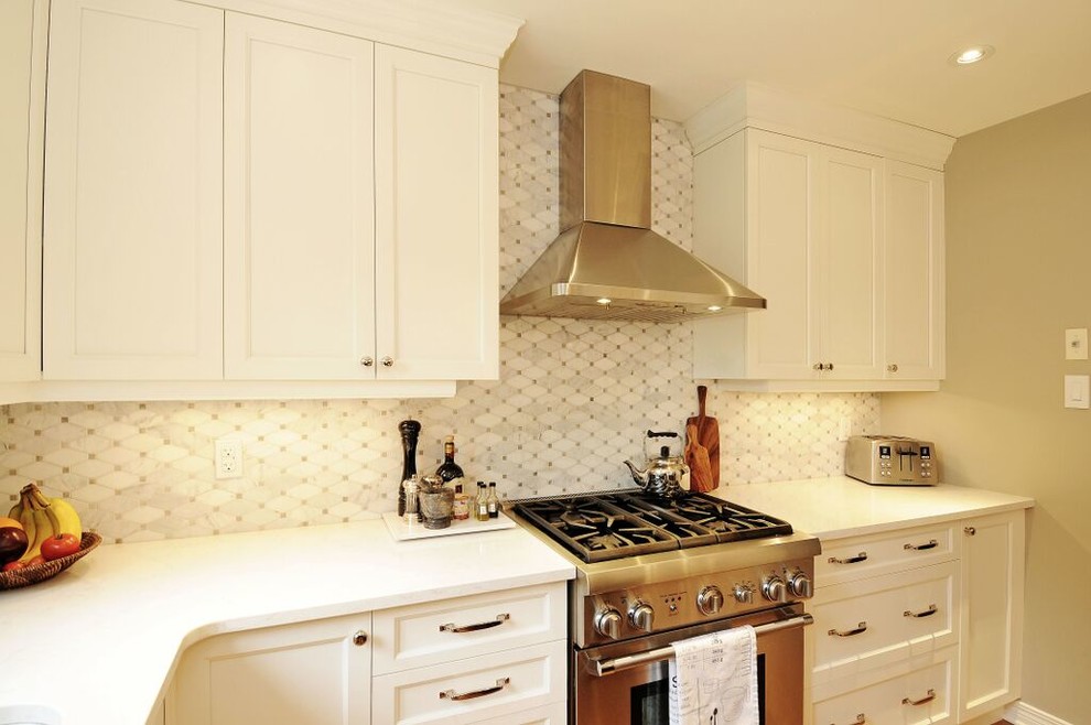 Example of a mid-sized transitional l-shaped medium tone wood floor kitchen design in Ottawa with a double-bowl sink, recessed-panel cabinets, white cabinets, quartz countertops, gray backsplash, stone tile backsplash, stainless steel appliances and an island