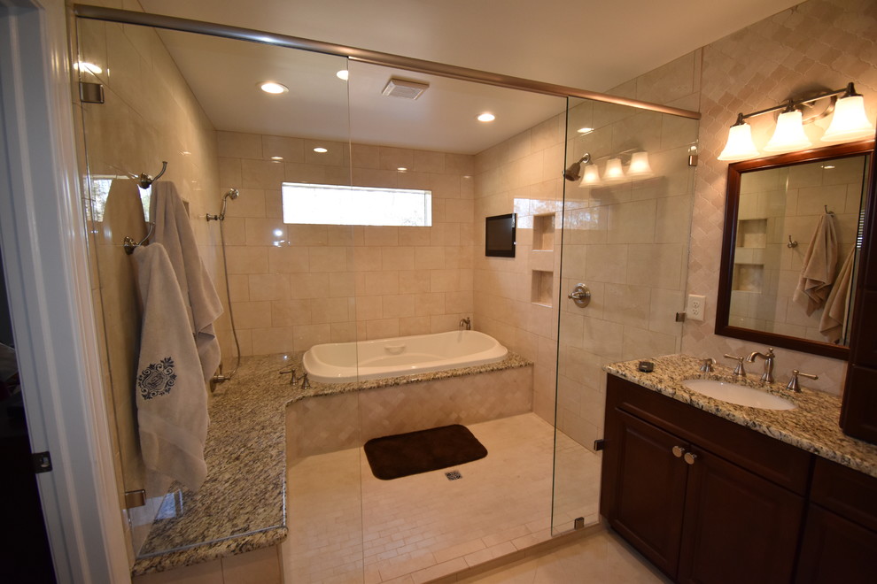 Traditional bathroom in Other with raised-panel cabinets, medium wood cabinets, a drop-in tub, beige tile, porcelain tile, porcelain floors, granite benchtops, beige floor and a hinged shower door.