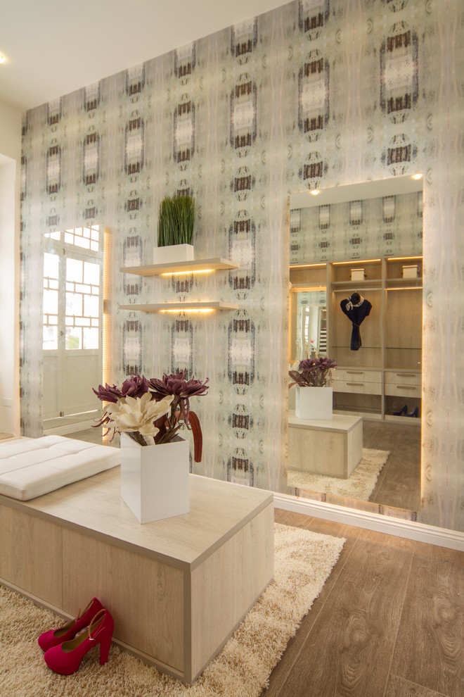 Inspiration for a mid-sized contemporary gender-neutral ceramic tile walk-in closet remodel in Houston with flat-panel cabinets and light wood cabinets