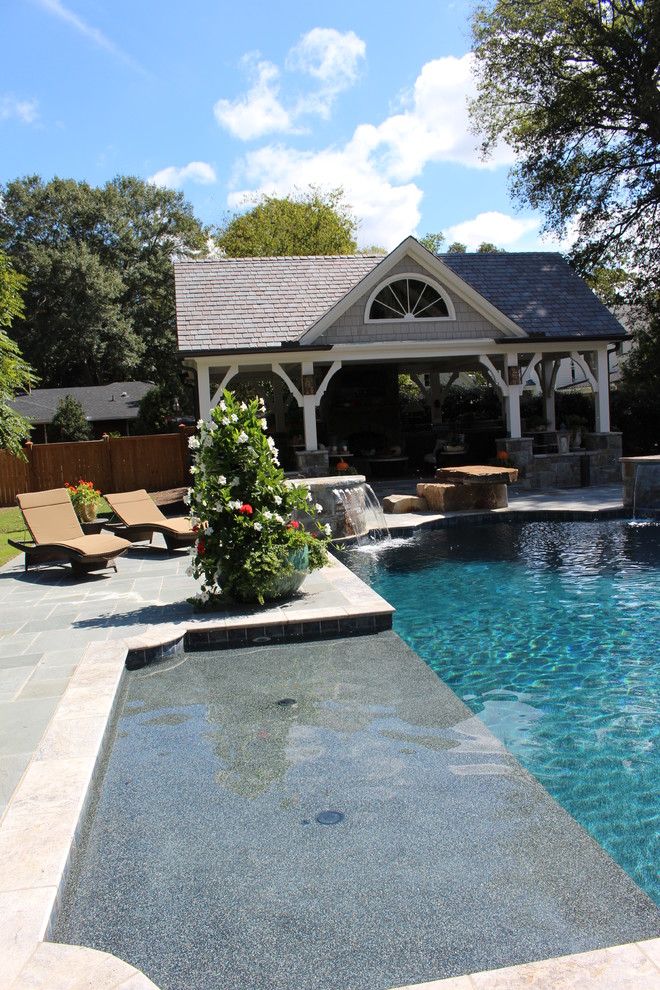 This is an example of a large traditional backyard rectangular pool in Atlanta with a pool house.