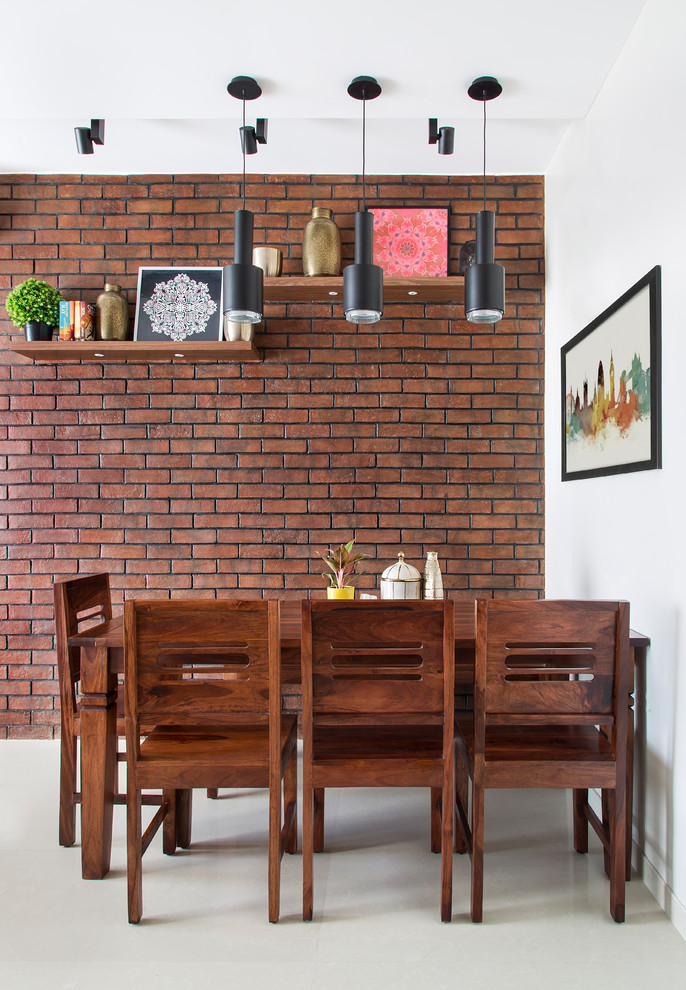 Photo of a contemporary dining room in Bengaluru with white walls and beige floor.