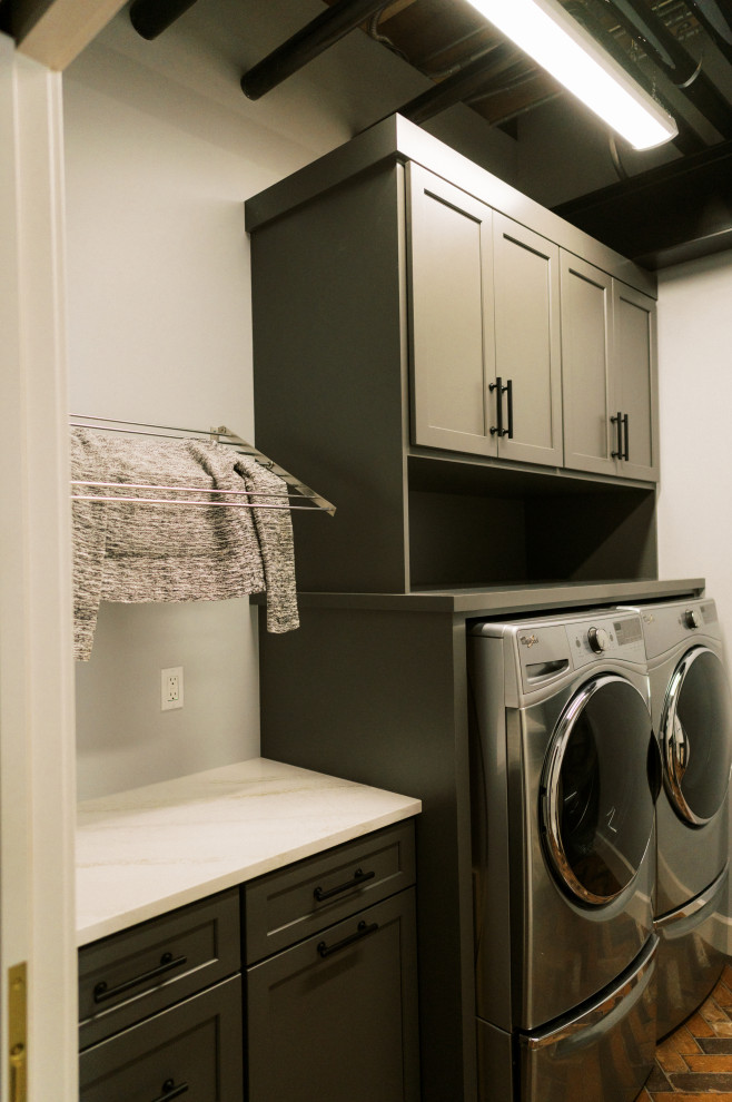 Inspiration for a mid-sized modern single-wall dedicated laundry room in Cedar Rapids with shaker cabinets, a side-by-side washer and dryer, multi-coloured floor, white benchtop, green cabinets, quartz benchtops and green walls.