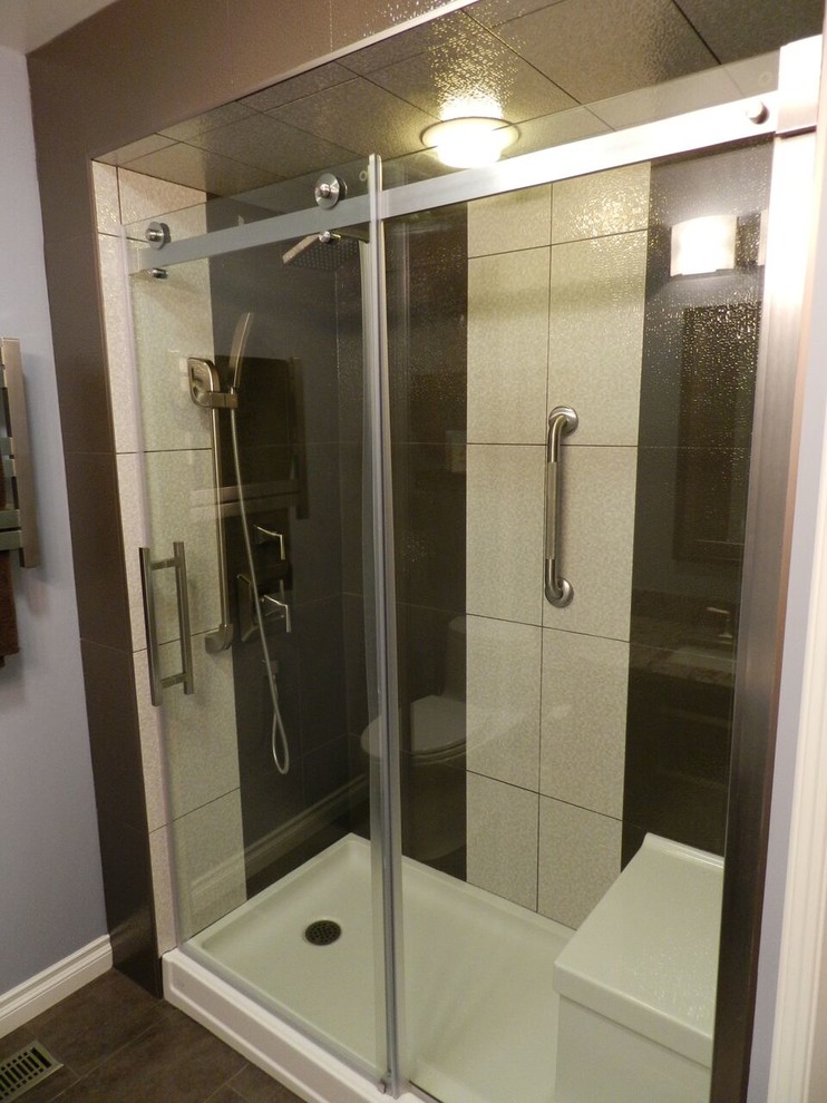 Example of a mid-sized transitional beige tile, brown tile and porcelain tile alcove shower design with a hinged shower door