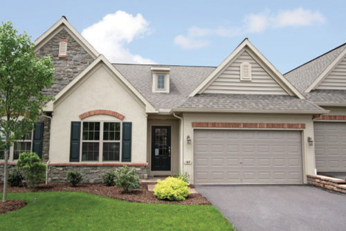 Inspiration for a large timeless two-story beige home design remodel