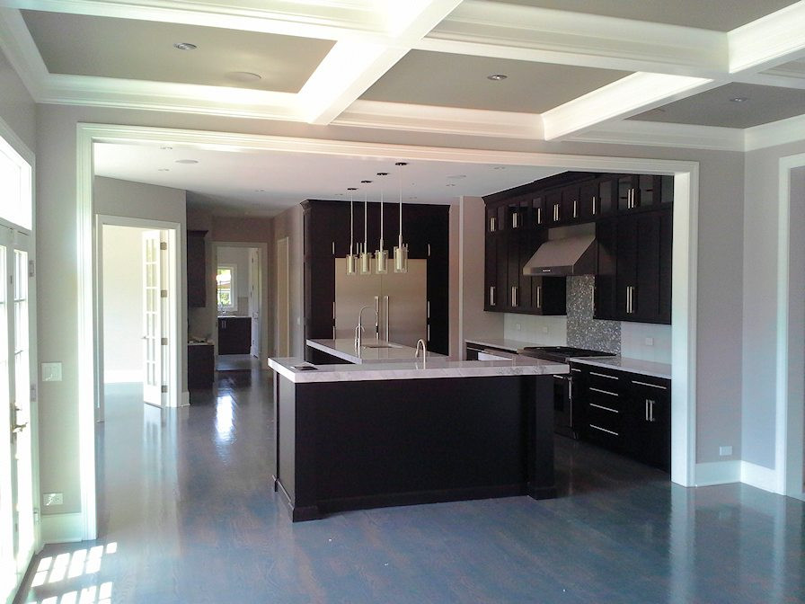 Inspiration for a large transitional u-shaped light wood floor and gray floor eat-in kitchen remodel in Chicago with an undermount sink, recessed-panel cabinets, black cabinets, quartz countertops, white backsplash, ceramic backsplash, stainless steel appliances, two islands and white countertops