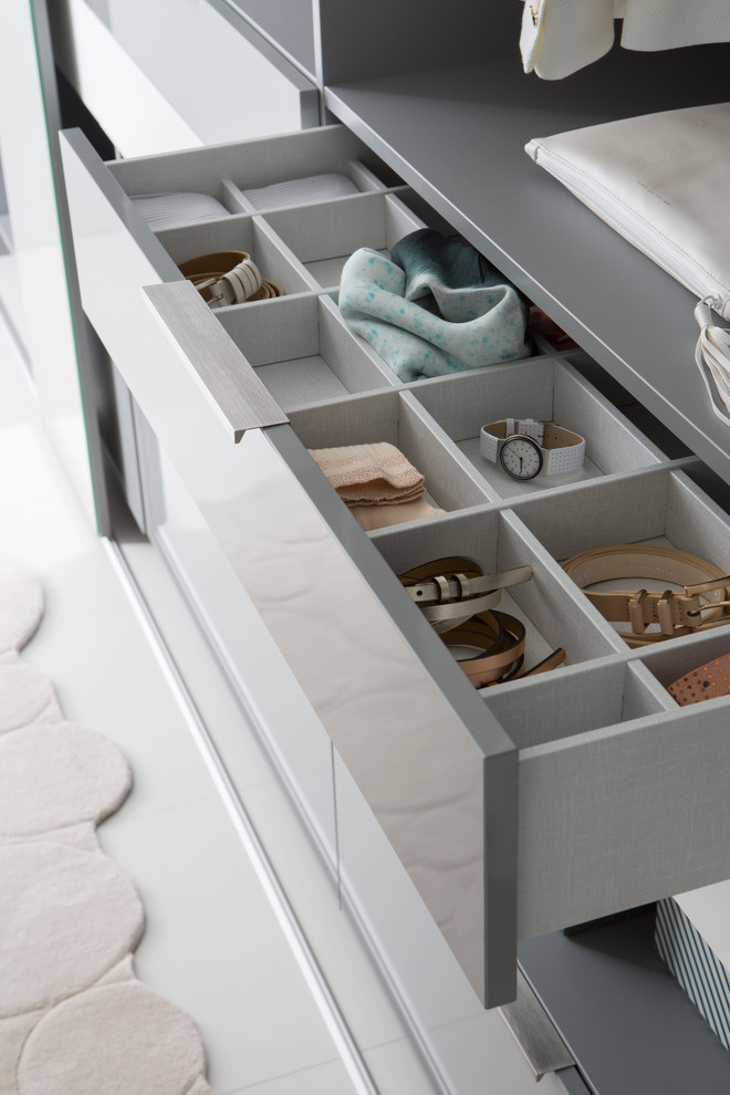 Inspiration for a large contemporary gender-neutral dressing room in Lyon with open cabinets and grey cabinets.