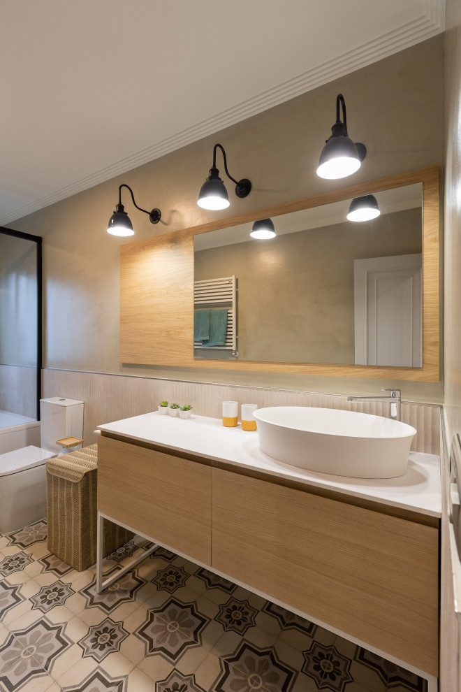 Design ideas for a medium sized ensuite bathroom in Other with flat-panel cabinets, white cabinets, a built-in bath, a one-piece toilet, multi-coloured tiles, ceramic flooring, a vessel sink, multi-coloured floors, white worktops, a single sink and a built in vanity unit.