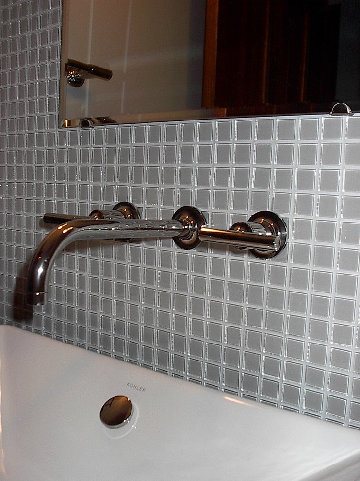 Small trendy gray tile and glass tile home design photo with flat-panel cabinets, white cabinets, gray walls, a vessel sink and quartzite countertops