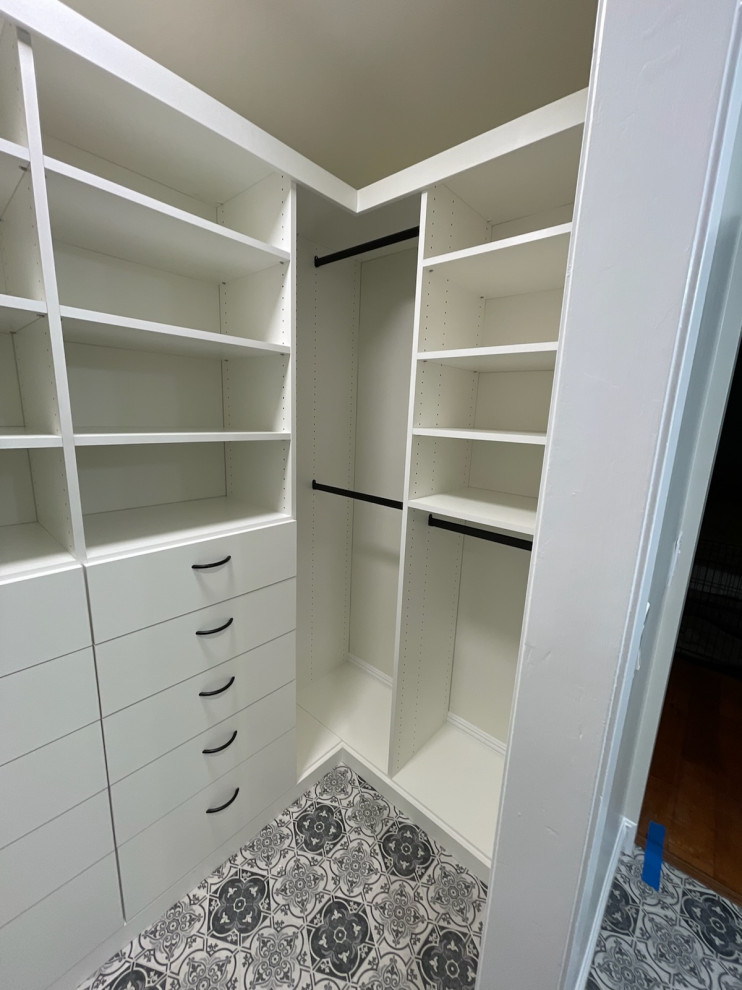 Design ideas for a small walk-in wardrobe in Los Angeles with flat-panel cabinets and white cabinets.