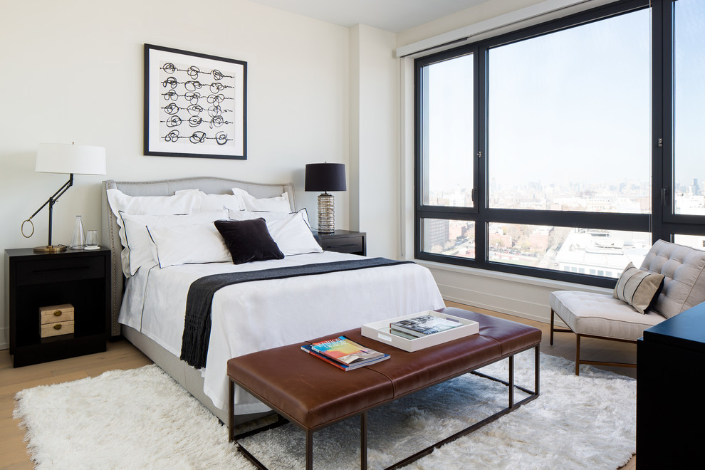 Inspiration for a contemporary master bedroom in New York with white walls and light hardwood floors.