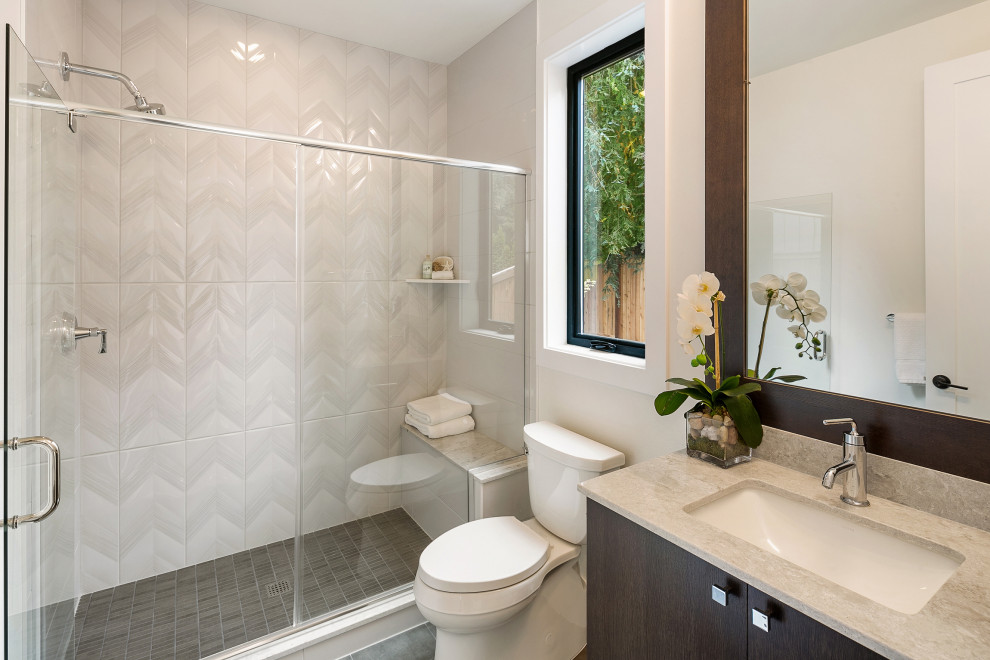 Medium sized modern shower room bathroom in Seattle with flat-panel cabinets, dark wood cabinets, an alcove shower, a two-piece toilet, white tiles, white walls, a submerged sink, engineered stone worktops, a hinged door, multi-coloured worktops, a shower bench, a single sink and a built in vanity unit.