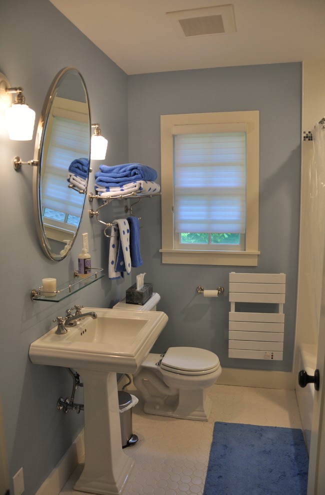 This is an example of a small traditional 3/4 bathroom in New York with a pedestal sink, an alcove tub, a shower/bathtub combo, a two-piece toilet, white tile, ceramic tile, blue walls and linoleum floors.