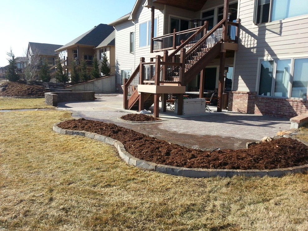 Inspiration for a large transitional backyard patio in Wichita.