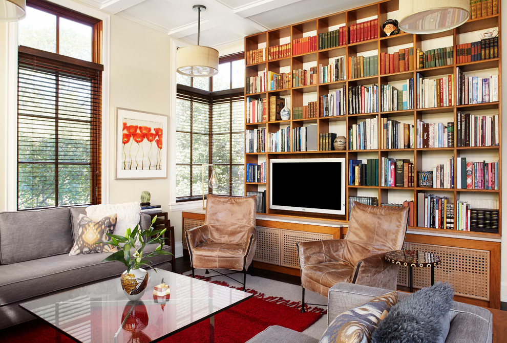 This is an example of a transitional living room in Chicago with a library and yellow walls.