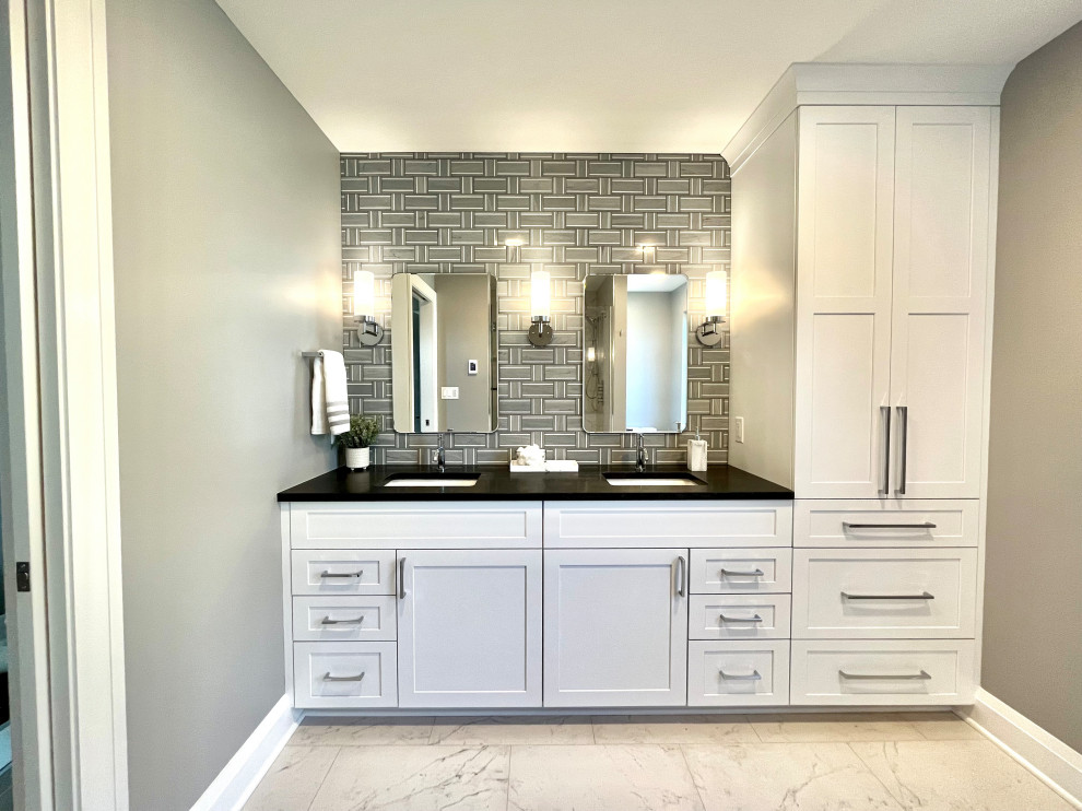 Inspiration for a mid-sized transitional master gray tile and stone tile porcelain tile, white floor and double-sink walk-in shower remodel with shaker cabinets, white cabinets, a two-piece toilet, gray walls, an undermount sink, granite countertops, a hinged shower door, black countertops and a built-in vanity