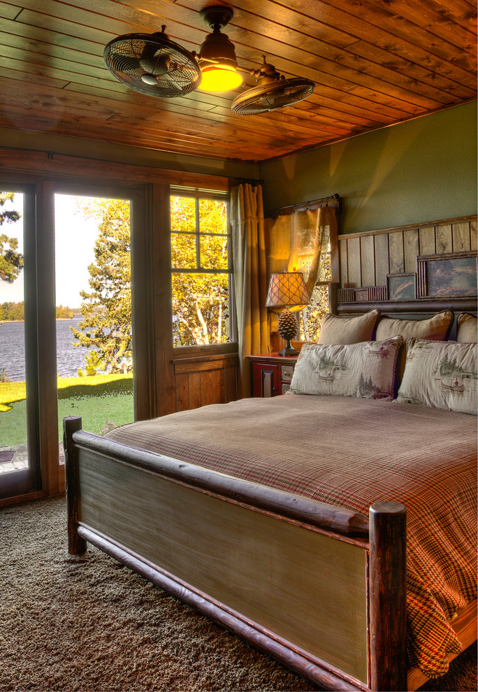 Photo of a country bedroom in Minneapolis with green walls and carpet.