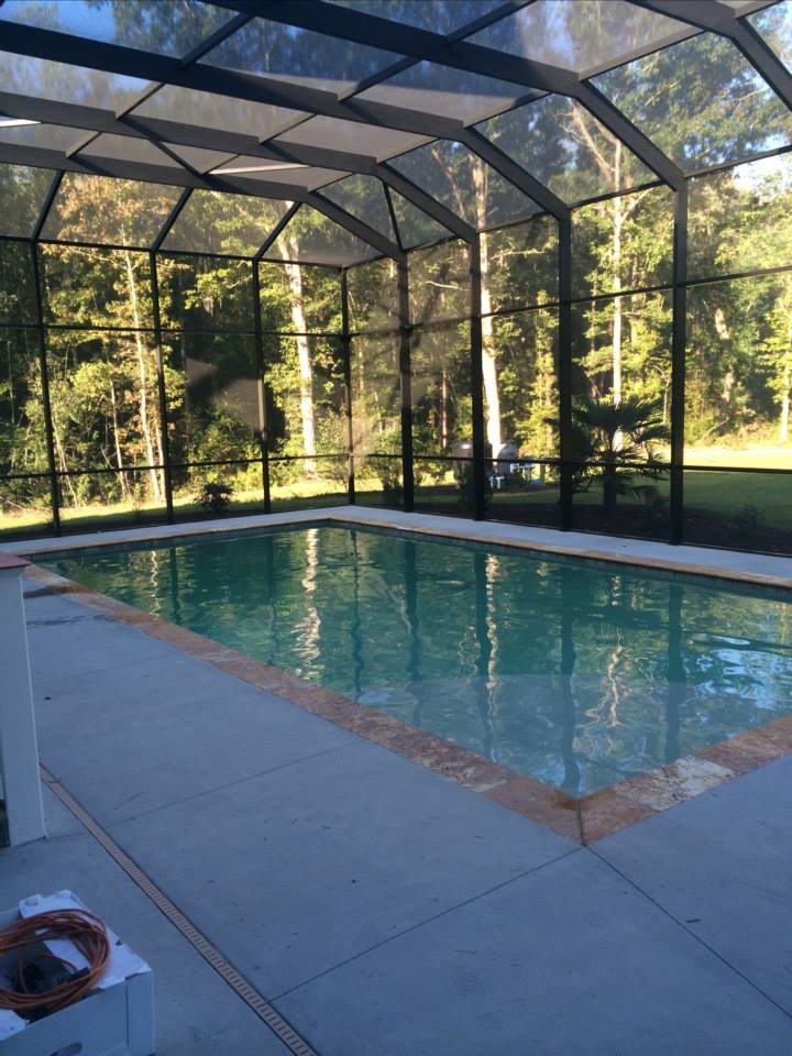 Backyard stamped concrete and rectangular pool photo