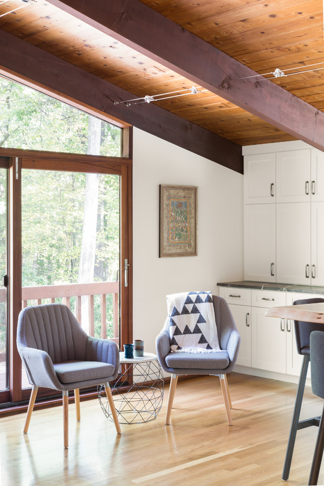 Inspiration for a large midcentury galley eat-in kitchen in Boston with an undermount sink, shaker cabinets, white cabinets, soapstone benchtops, stainless steel appliances, light hardwood floors and with island.