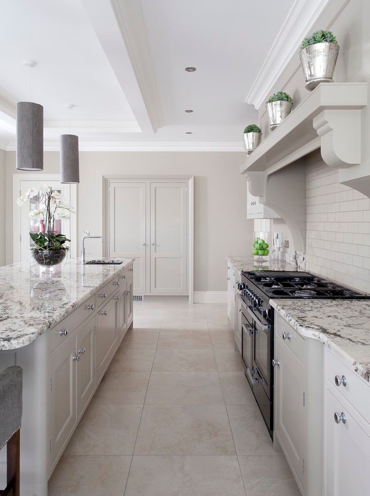 Design ideas for a large transitional open plan kitchen in Other with an integrated sink, beaded inset cabinets, grey cabinets, granite benchtops, beige splashback, subway tile splashback, panelled appliances, ceramic floors and with island.