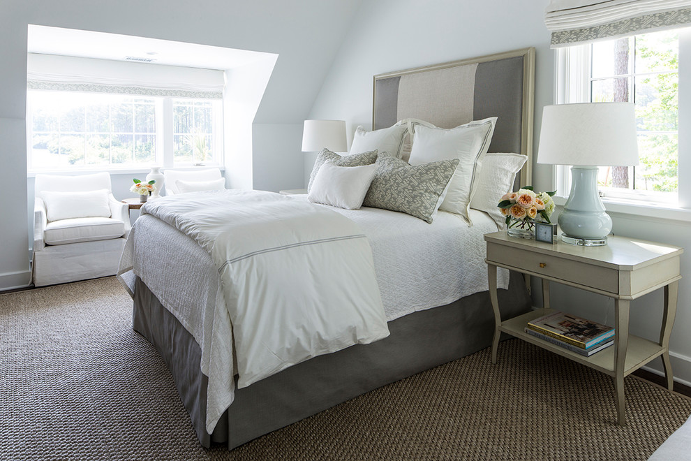 Inspiration for a beach style master bedroom in Charlotte with white walls.