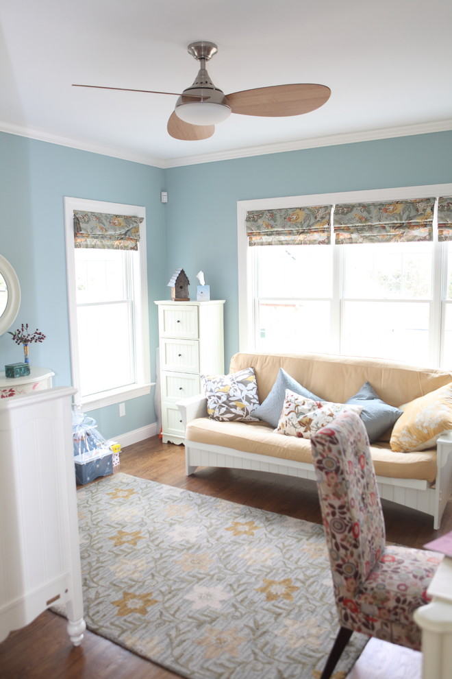 Design ideas for a mid-sized traditional nursery for boys in Providence with blue walls and medium hardwood floors.