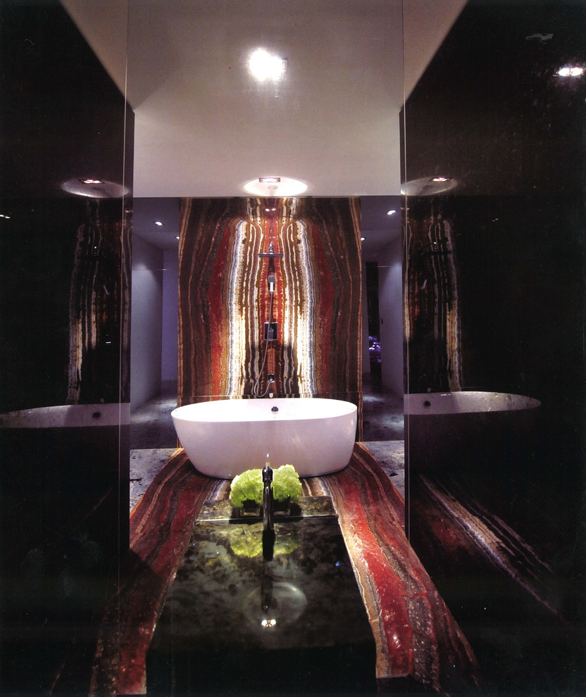 Large eclectic master bathroom in Toronto with a freestanding tub, stone slab and multi-coloured walls.
