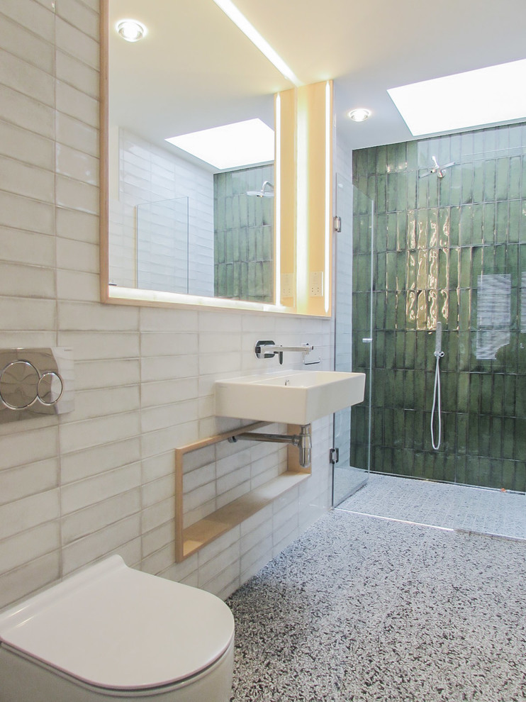 This is an example of a contemporary bathroom in Other with green walls and terrazzo floors.