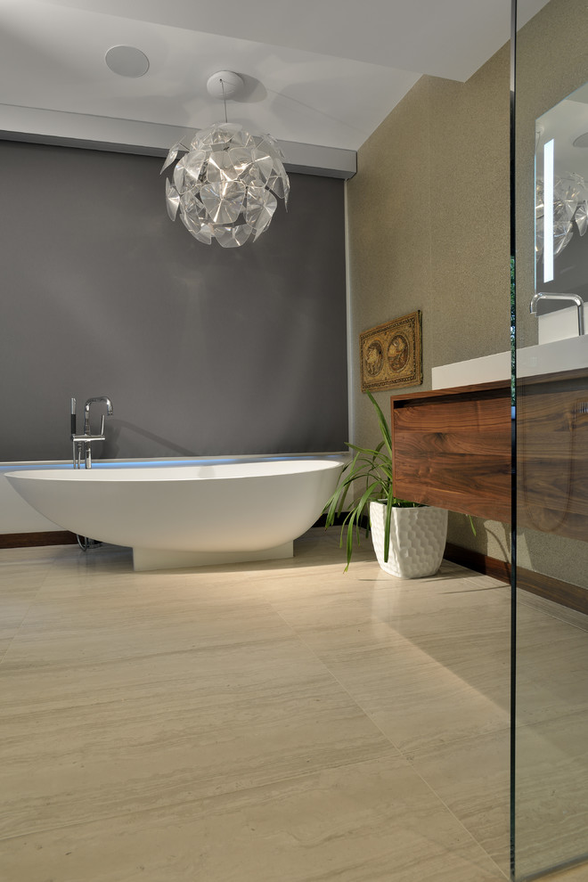 This is an example of a contemporary bathroom in Toronto with flat-panel cabinets, dark wood cabinets, beige tile, a vessel sink and wood benchtops.