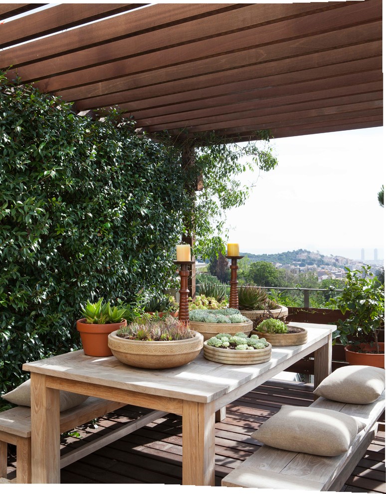 Photo of a mid-sized mediterranean patio in Barcelona with a vertical garden and a pergola.
